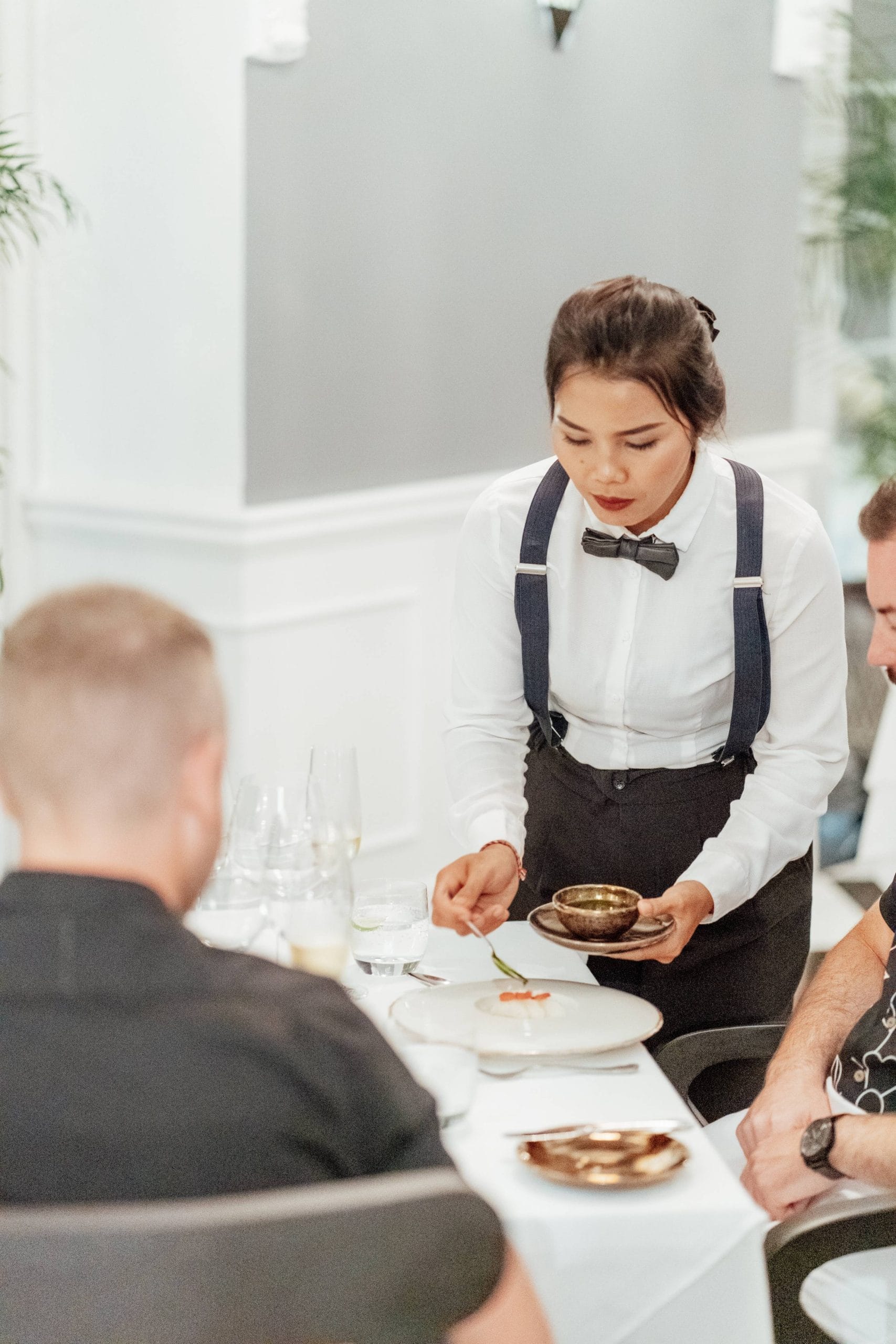 A caterer staff member serving a guest at a corporate gathering in Bali