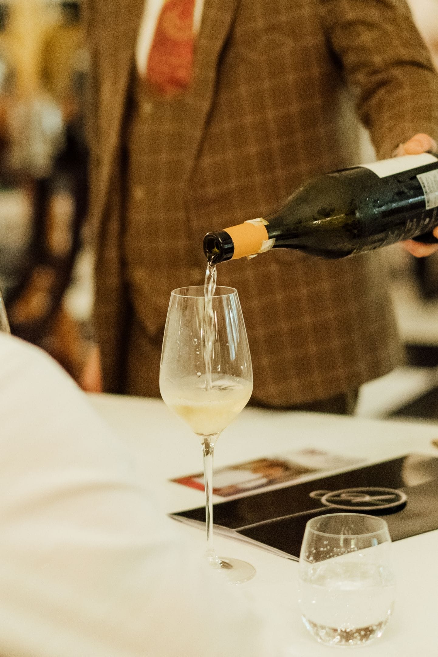 A staff member pouring champagne into a glass