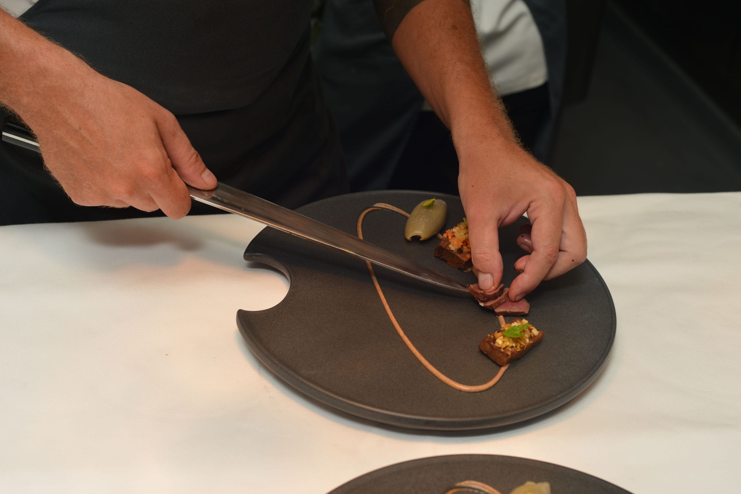 A professional chef caterer preparing a gourmet entree in Bali