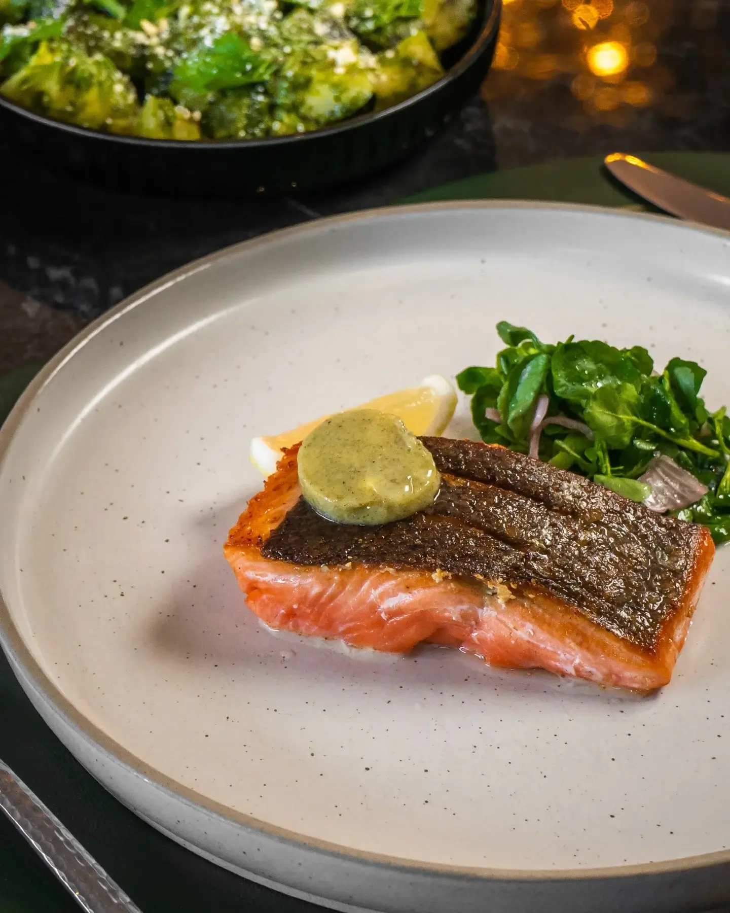 A gourmet meal of salmon, herbed butter and salad