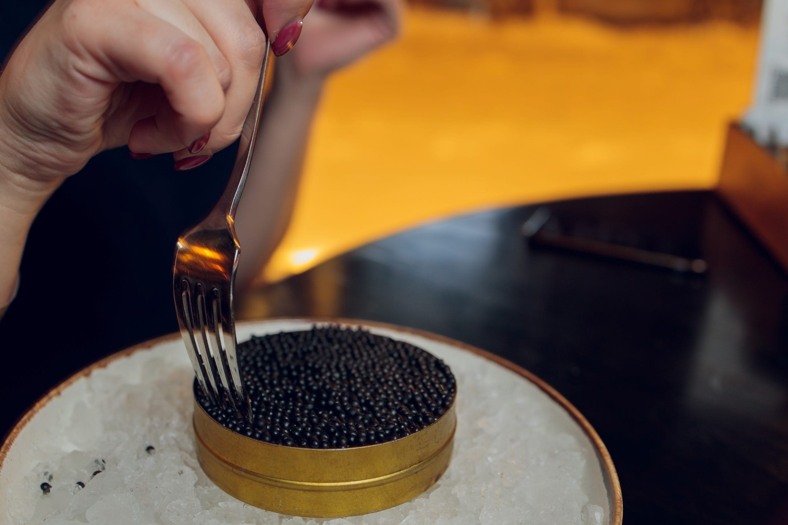 Bali caviar service with a container of caviar displayed elegantly on a bed of salt