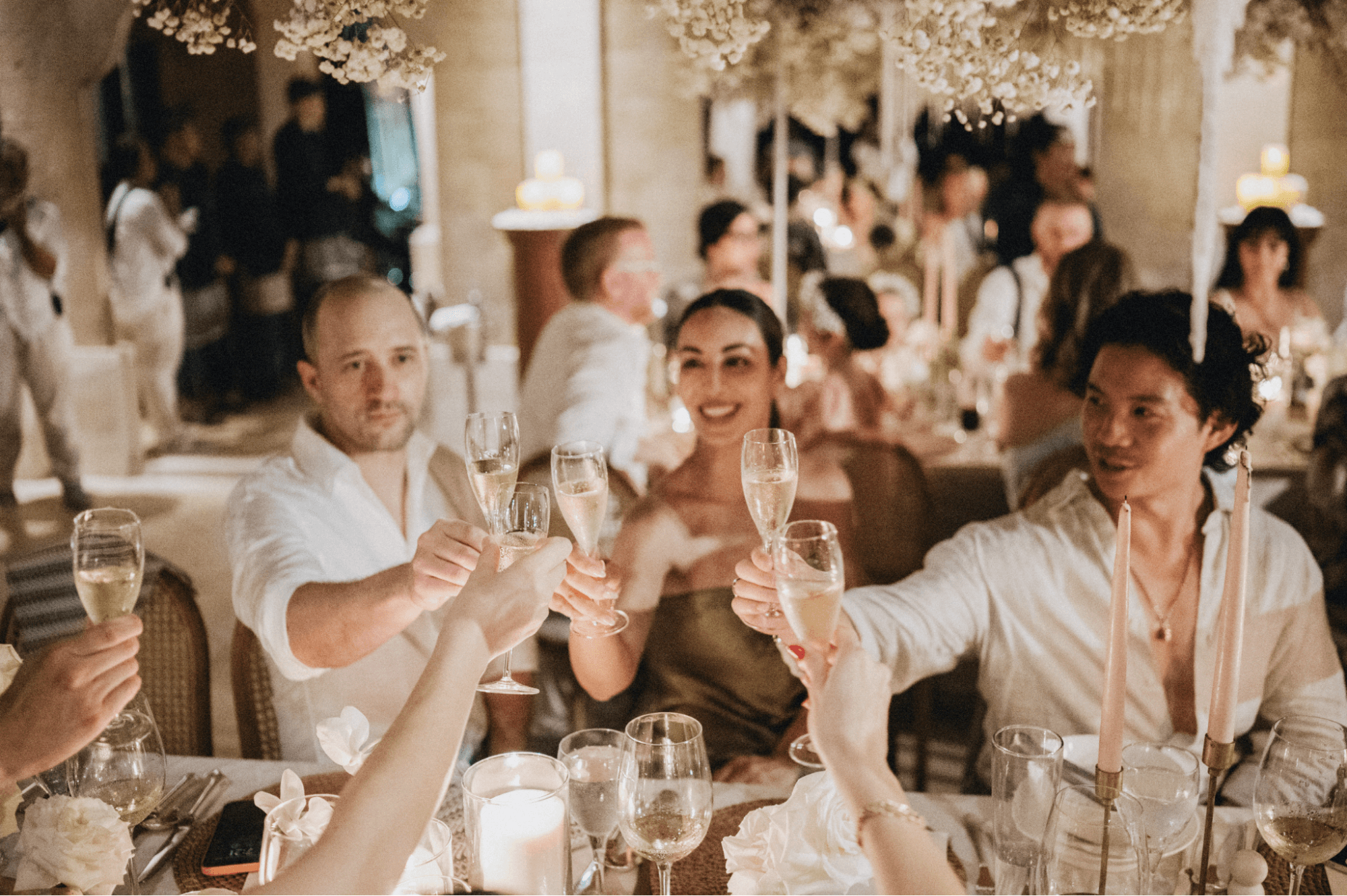Wedding guests cheersing champagne classes