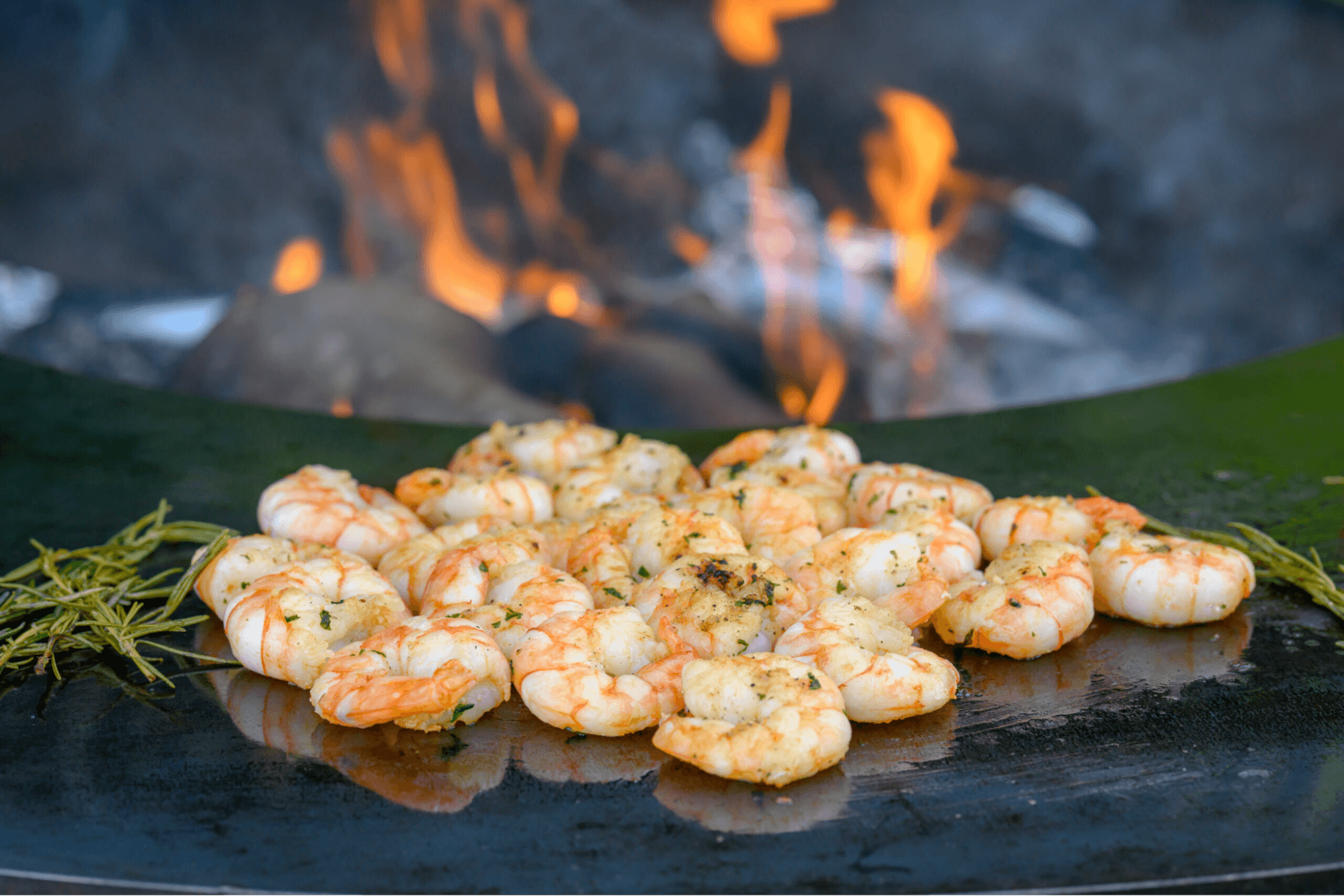 Shrimps grilling on a flame barbeque