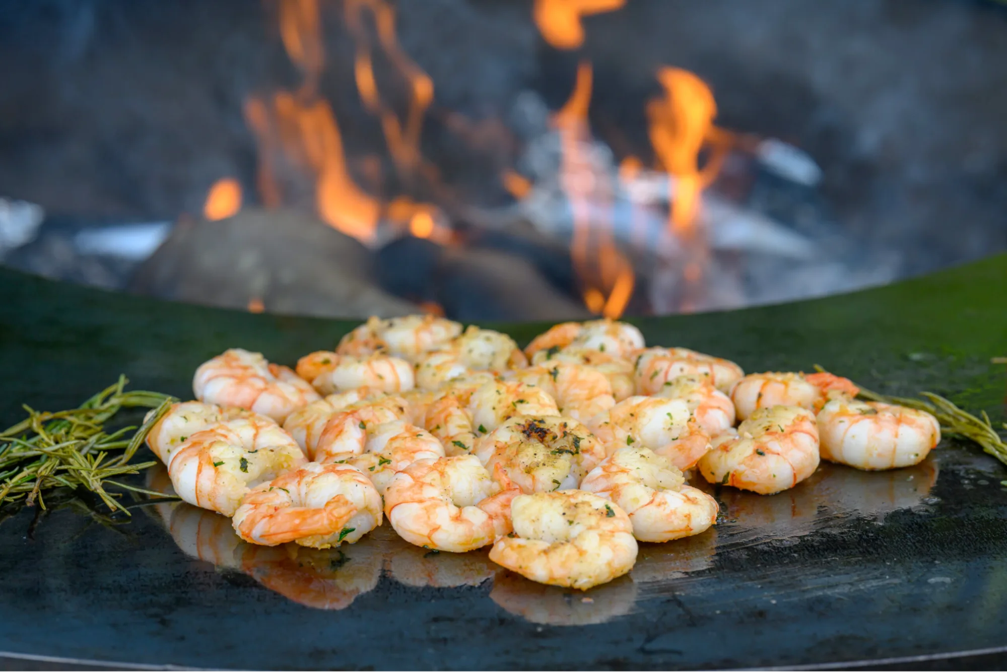 Shrimps grilling on a flame barbeque