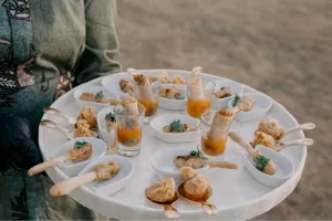 A caterer holding a plate of canapés