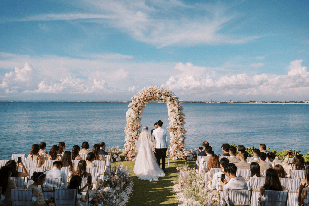 A ocean view wedding with the bride and groom standing at the alter
