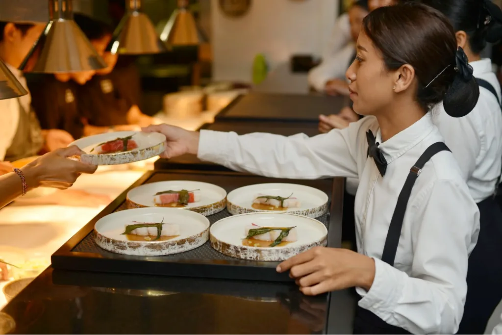 A Bali caterer serving plates