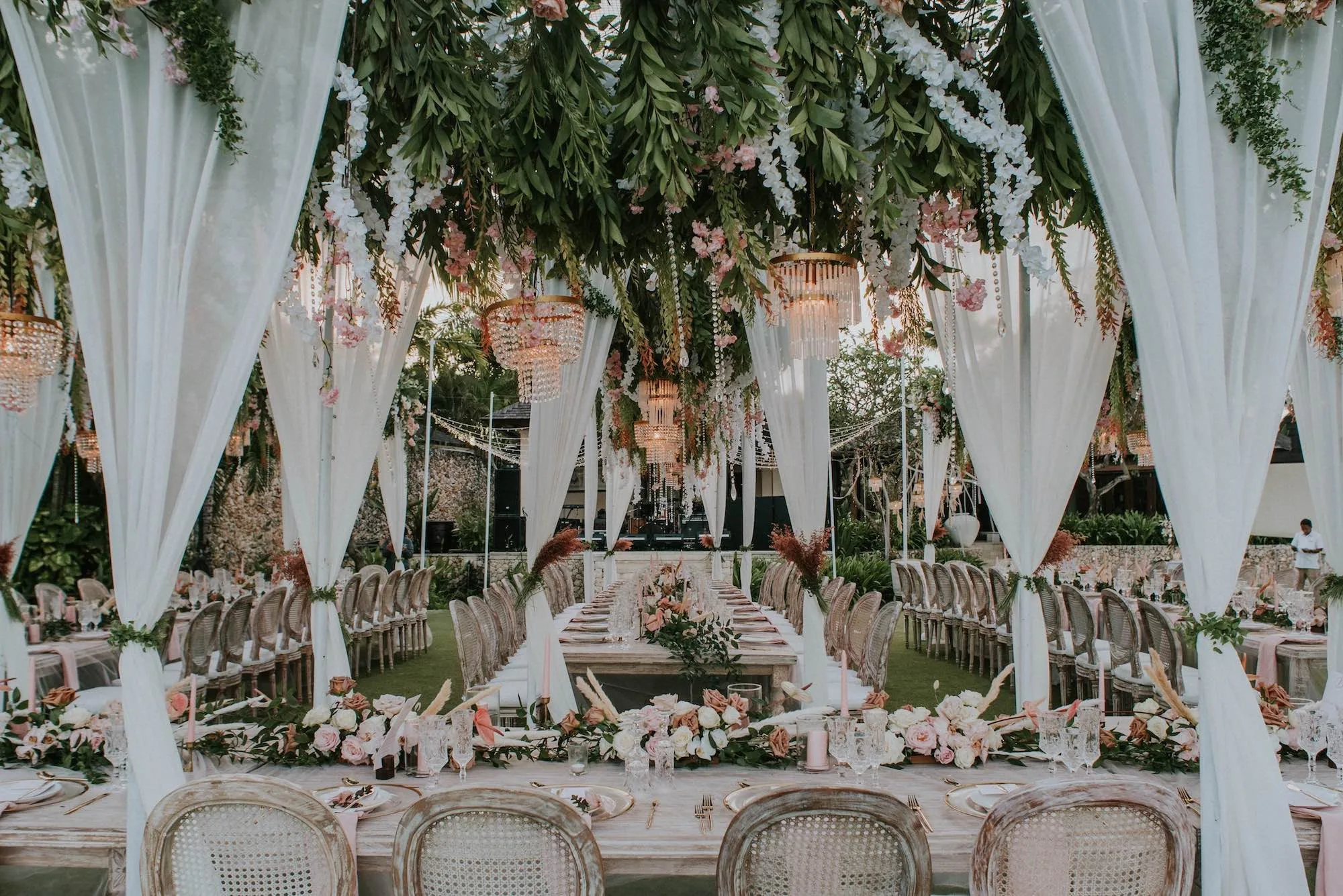 An elegant wedding in Bali with table settings decorated with flowers