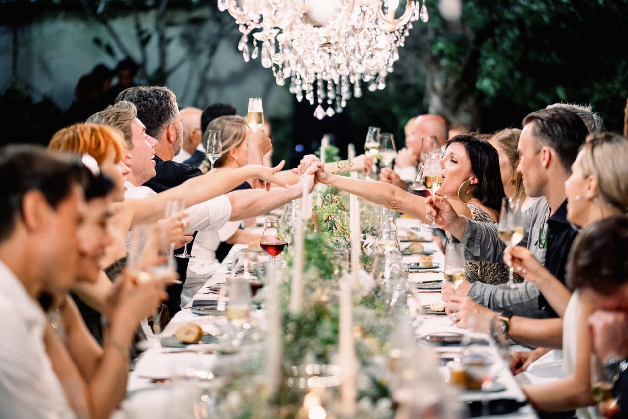 Guests at a wedding seated at a long table