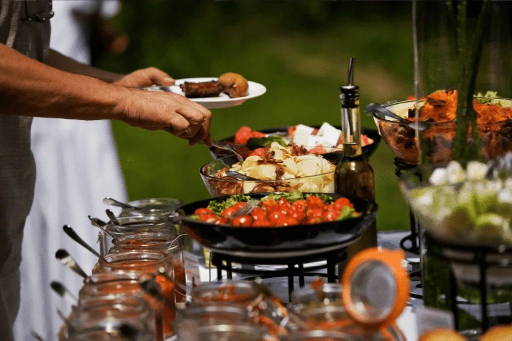 A guest helping themselves from a buffet style catered meal
