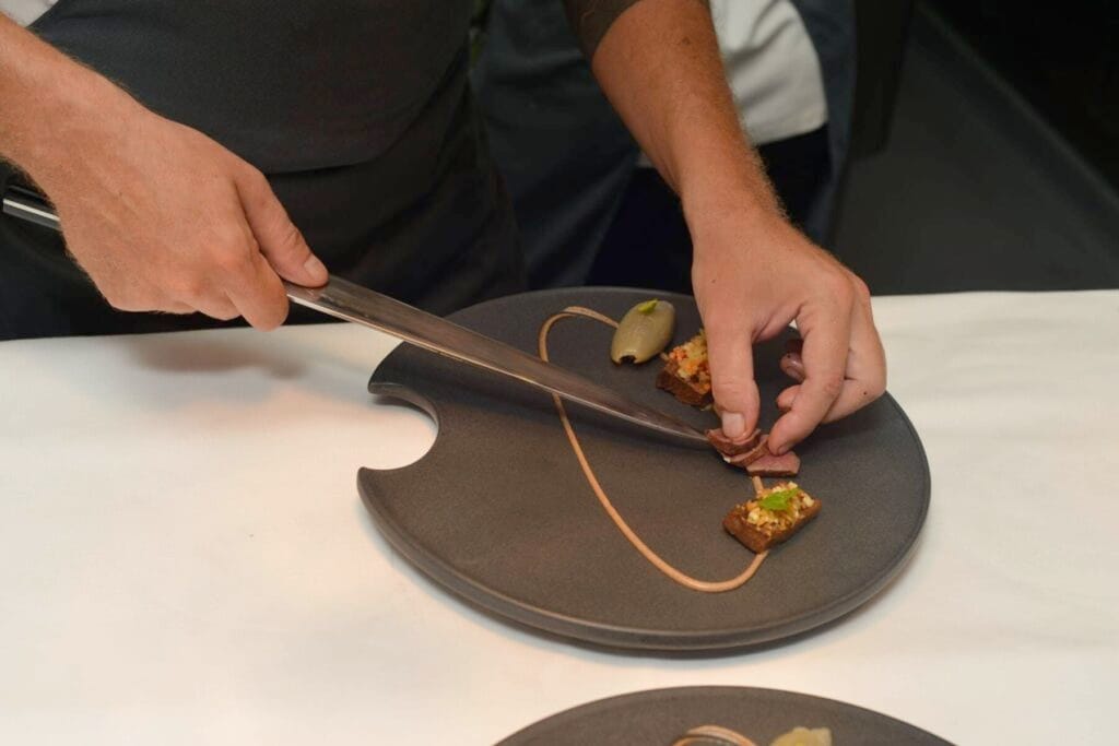 A caterer preparing an elegant dish