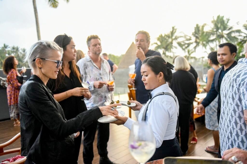 A caterer serving guests at an event in Bali