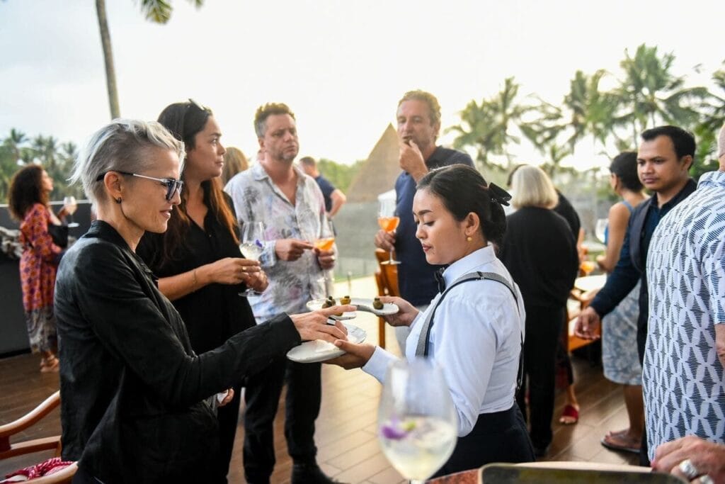 A caterer in Bali serving guests at an event