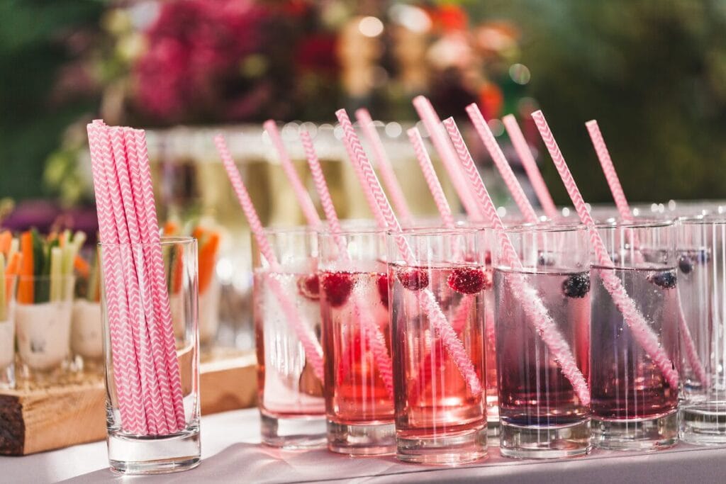 Drinks with berries sitting next to canapes at a wedding