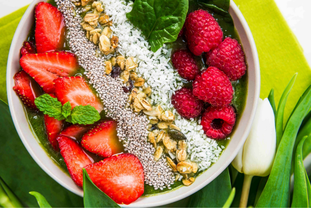 A colourful smoothie bowl with a range of fruits, seeds and toppings